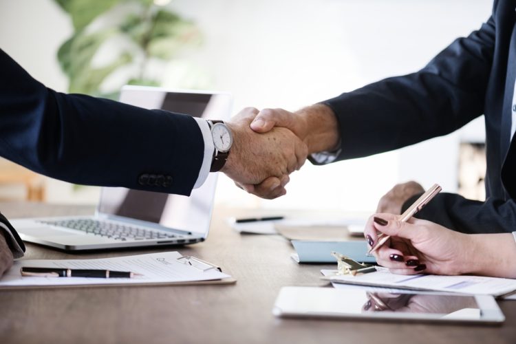 Businessmen shaking hands over a non disclosure agreement