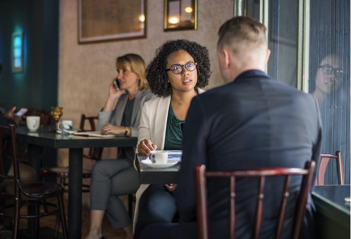 couple in cafe discussing pre nup contracting out agreement