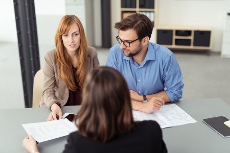 lawyer discussing relationship property agreement with couple