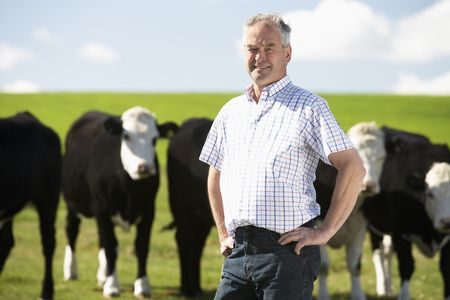 farmer in paddock thinking about farm succession planning